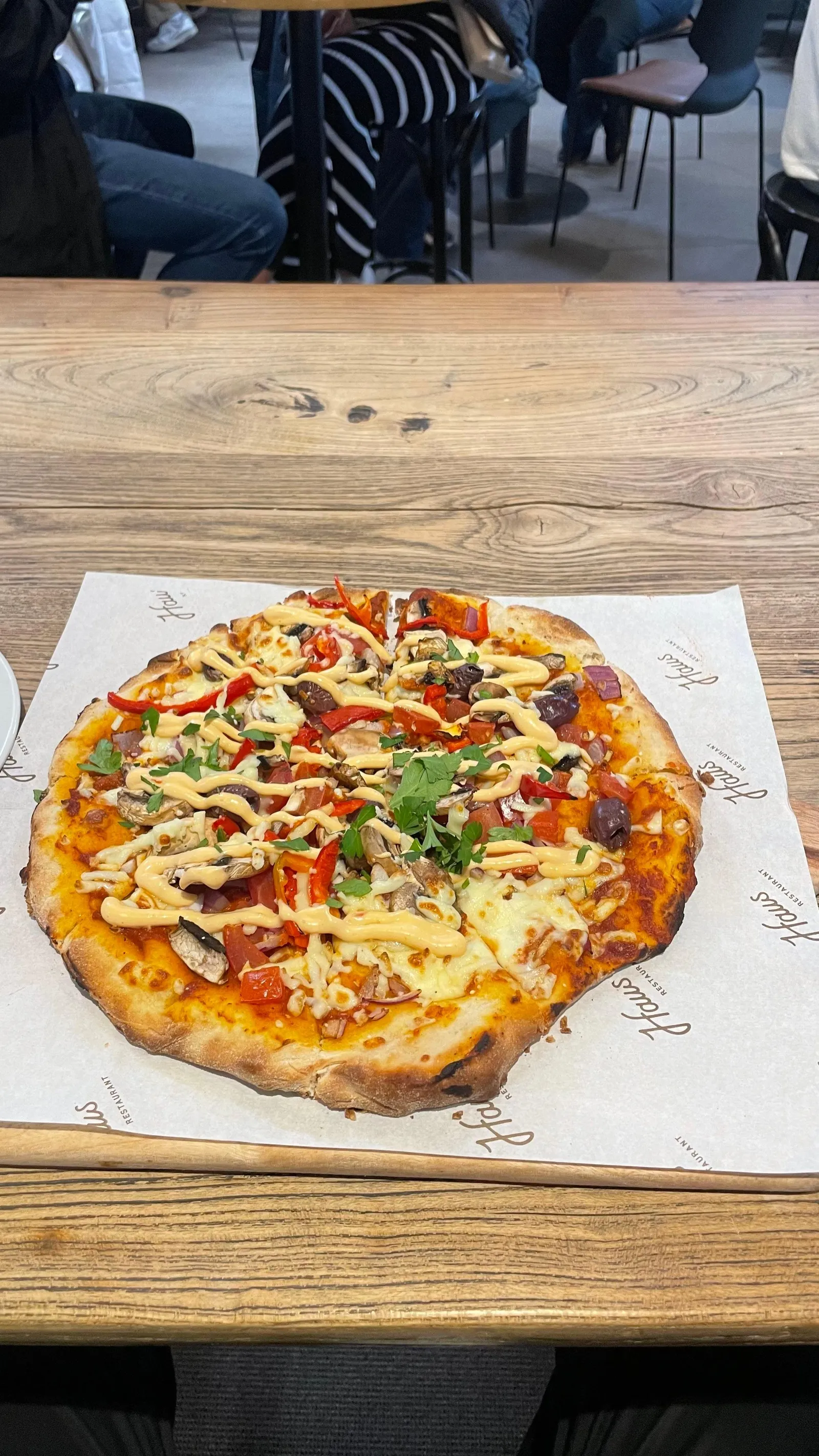 A wood-fired pizza on a table at a Hills venue
