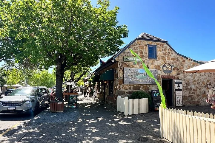 Stone cottage and shady footpath on Hahndorf Main Street