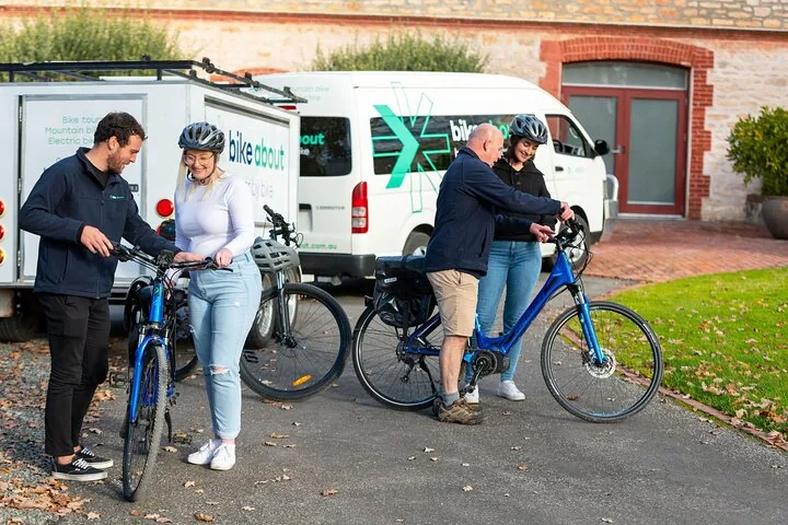 Guests collecting e-bikes and helmets from the support van